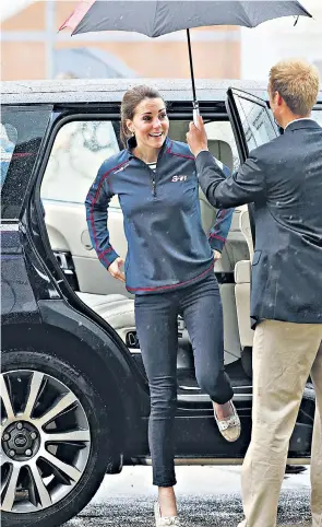  ??  ?? An umbrella for the Duchess of Cambridge as she arrived in Portsmouth yesterday, when she and the Duke wore Ben Ainslie Racing (BAR) jackets with their royal titles on the back and chatted to spectators and their children, including one who was not...