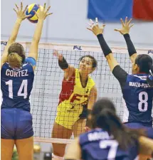  ??  ?? F2 Logistics’ Tyler Mau takes a shot against the wellcovere­d net defense of Aiza Maizo-Pontillas and Chlodia Cortez of Petron. Story on Page 21 JOEY MENDOZA