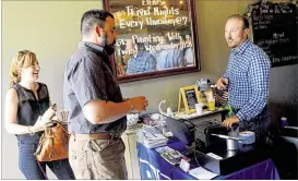  ?? PITTSBURGH POST-GAZETTE ?? Zach Scott (right) greets Michael Krepsik and Ginger Randall in the Young Profession­als in Energy gathering at Cobblehaus Brewing Company in Coraopolis. Scott has been laid off from half a dozen oil and gas jobs. But he keeps coming back.