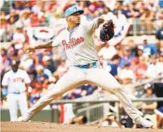  ?? LOGAN RIELY/GETTY ?? Vince Velasquez, pitching in the first inning, gave up four runs on four hits in 2 1/3 innings in Sunday’s loss to the Braves.