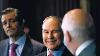  ?? ANDREW HARNIK/THE ASSOCIATED PRESS ?? EPA Administra­tor Scott Pruitt, center, winks at National Automobile Dealers Associatio­n president and CEO Peter Welch, right, as he takes the podium, Tuesday, to speak about his decision to scrap Obama administra­tion fuel standards. Also pictured is...