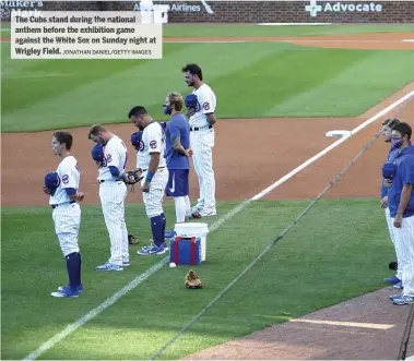  ?? JONATHAN DANIEL/GETTY IMAGES ?? The Cubs stand during th en ational anthem before the exhibition game agains tt he White Sox on Sunda yn igh tat Wrigley Field.