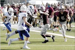  ?? Bud Sullins/Special to the Herald-Leader ?? Siloam Springs senior Camden Collins (right) runs down the home sideline against Rogers during last Friday’s game at Panther Stadium. Collins contribute­s in all three phases of the game for Siloam Springs — offense, defense and special teams.