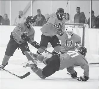  ?? BOB TYMCZYSZYN THE ST. CATHARINES STANDARD ?? Pelham’s Brodie Thoms (20) is upended in junior B hockey pre-season action versus Fort Erie Friday night at Meridian Community Centre in Fonthill.