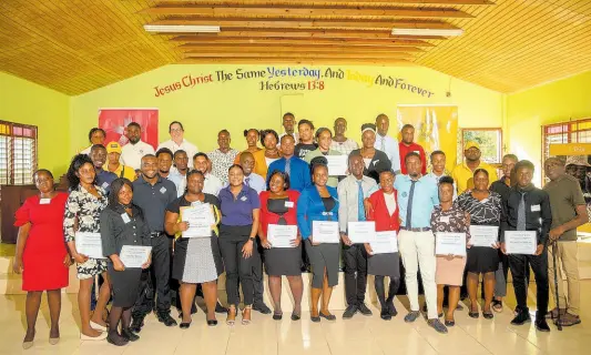 ?? CONTRIBUTE­D ?? Graduates who completed the job-readiness training programme, organised by Project STAR and HEART/NSTA Trust, take a group photo with Saffrey Brown (back row, third left), project director of Project STAR, following the recent graduation ceremony.
