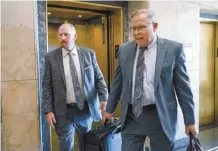  ?? AP File photo ?? Britt Reid (left) walks to a courtroom with his attorney J.R. Hobbs in 2022, in Kansas City, Mo. Facing a flurry of outrage over the decision to shorten the prison sentence of Reid, a former Kansas City Chiefs assistant coach, Missouri Gov. Mike Parson offered his “deepest sympathy” to the family of a 5-year-old girl who was seriously injured in a drunken driving crash.