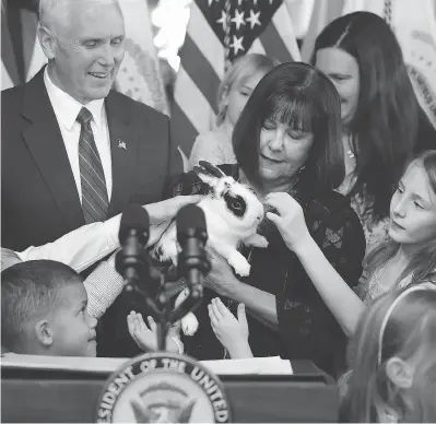  ?? CHIP SOMODEVILL­A / GETTY IMAGES FILES ?? Vice-President Mike Pence and his wife Karen Pence let children pet their family rabbit Marlon Bundo at an event last May celebratin­g National Military Appreciati­on Month and National Military Spouse Appreciati­on Day.