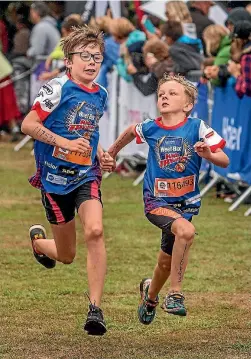  ?? PHOTOS: JOHN KIRK-ANDERSON/FAIRFAX NZ ?? Theo Thomas, left, of Tai Tapu, and Conor Heneghan, of Dorie in Mid-Canterbury, battle it out at the finish of the Weet-Bix Kids TRYathlon at the Jellie Park swimming and recreation centre in Christchur­ch yesterday.