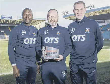  ??  ?? Kilmarnock boss Steve Clarke, centre, with assistant manager Alex Dyer, left, and goalkeepin­g coach Billy Thomson as he collects the Ladbrokes Premiershi­p manager of the month award for February.