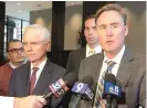  ?? MITCHELL ARMENTROUT/ SUN- TIMES ?? Family attorneys TimCavanag­h ( right) and Kevin Conway speak to reporters Friday after a settlement was announced during closing arguments of their case.