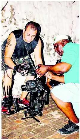  ?? CONTRIBUTE­D ?? Kurt Wright, director with Delroy Johnson, camera technician in set.