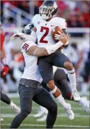  ?? RICK BOWMER - THE ASSOCIATED PRESS ?? Washington State’s Hercules Mata’afa (50) lifts Robert Taylor (2) after his intercepti­on against Utah in the first half of an NCAA college football game, Saturday, Nov. 11, 2017, in Salt Lake City.