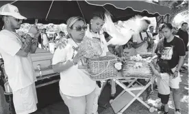  ?? Photos by Jerry Lara/staff photograph­er ?? Lynda Espinoza releases a white dove symbolizin­g her son’s spirit during his burial service. Family and activists say they will pursue justice for the boy.