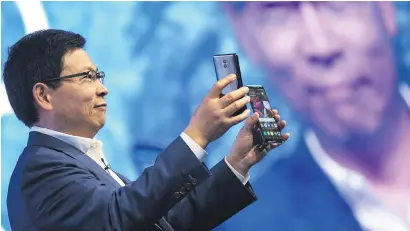  ?? Pictures: EPA-EFE ?? HANDS FULL. Huawei CEO Richard Yu presents new Huawei Mate 10 and Mate 10 Pro phones during the recent launch in Munich, Germany.