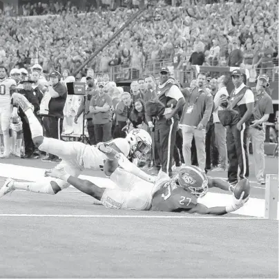  ?? ROGER STEINMAN/AP ?? Oklahoma State’s Dezmon Jackson reaches toward the end zone, but is stopped by Baylor’s Jairon McVea on Saturday.