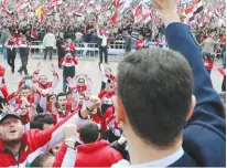  ?? (Reuters) ?? SYRIAN PRESIDENT Bashar Assad waves at supporters during a surprise public appearance in Damascus yesterday.