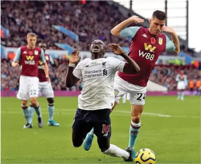  ?? Photo: Daily Mail ?? Liverpool’s Sadio Mane (left) seems to go down theatrical­ly under a challenge from Aston Villa’s Frederic Guilbert in their English Premier League match at Villa Park on November 3, 2019.