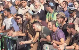  ?? GIL COHEN-MAGEN/AFP VIA GETTY IMAGES ?? Mourners attend the funeral of Israeli settlers Yagel Yaniv and Hillel Yaniv at the military cemetery in Jerusalem on Monday.