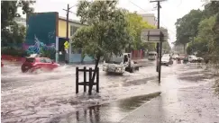 ??  ?? Vehicles drive on a flooded street in Sydney yesterday in this still image taken from a video obtained from @DeeCee451’s Twitter account.