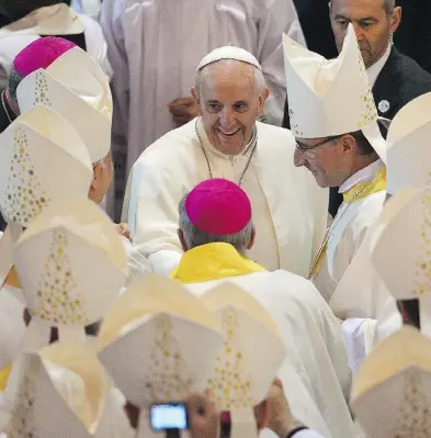  ?? GABRIEL BOUYS / AFP FILE PHOTO ?? Pope Francis is greeted in Rio de Janeiro during a 2013 visit. The Pope is considerin­g a partial lifting of priestly celibacy.