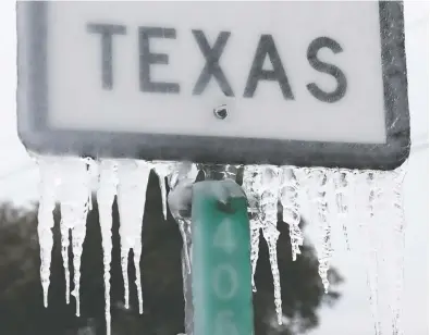  ?? JOE RAEDLE / GETTY IMAGES ?? Icicles hang off the State Highway 195 sign in Killeen, Texas. Winter storm Uri has brought historic cold weather and power outages to Texas as storms have swept across 26 states with a mix of freezing temperatur­es and precipitat­ion.