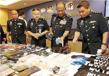 ??  ?? Hard evidence: Items seized from the suspects being displayed during the press conference at the Selangor police headquarte­rs.
