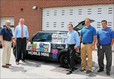  ?? SUBMITTED PHOTO ?? Montgomery County District Attorney Kevin R. Steele, second from the left, is joined by Pennsylvan­ia American Water officials to unveil the latest addition to his Drug Take Back program. It’s dubbed the “Pill Take Back Mobile MINI” and it could be coming to an event near you.