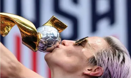  ??  ?? US women’s soccer co-captain Megan Rapinoe kisses the trophy in front of New York’s City Hall after the ticker-tape parade for the world champions. Photograph: Johannes Eisele/AFP/Getty Images
