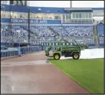  ??  ?? Associated Press
WET WEATHER —
Rain delays the start of the baseball game between the Los Angeles Angels and Toronto Blue Jays on Sunday in Dunedin, Fla. The game was eventually postponed and will be made up at Angel Stadium in August.