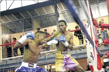  ?? PHOTO: MARK ANDREWS ?? TOUGH: In what can only be described as a miss-match, Siphamandl­a Baleni [in blue] inflicted so much damage to Iviwe Mgema at the Indoor Centre on Sunday. Baleni stopped Mgema in fourth round