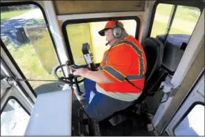  ?? Arkansas Democrat-Gazette/STATON BREIDENTHA­L ?? Brian Hayes, with the Arkansas Highway and Transporta­tion Department, operates a road striping machine Thursday on Arkansas 216 near Houston.