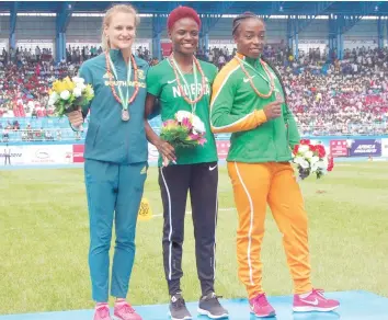  ??  ?? Gold medalist Nigeria’s Oluwatobil­oba Amusan (C), silver medalist South Africa’s Rickenette Steenkamp (left) and Ivory Coast’s bronze medalist (right) pose with their medals in the women’s 100m hurdles event yesterday