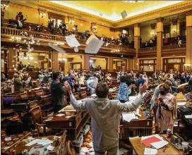  ?? ALYSSA POINTER/ALYSSA.POINTER@AJC.COM ?? Keeping with a somewhat messy tradition, members of the state House of Representa­tives throw papers in the air after Sine Die, the ancient Latin declaratio­n that the 40-day session of the General Assembly had come to a close.