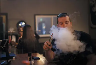  ?? DAI SUGANO — STAFF FILE ?? Anthony Bugna, of San Jose, exhales at The Vape Bar in San Jose. San Jose Councilwom­an Magdalena Carrasco has called for a ban on the sale of e-cigarettes and flavored tobacco products in the nation’s 10th largest city.