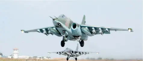  ?? VLADIMIR KONDRASHOV/The Associated Press ?? A Russian Su-25 jets take off from Hemeimeem airbase in western Syria for a mission on Thursday. The Russian defence ministry flew
Moscow-based reporters to the airbase, giving a few internatio­nal news organizati­ons their first inside look at its...