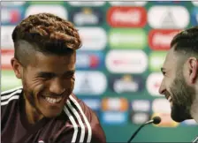  ?? AP PHOTO/EDUARDO VERDUGO ?? Mexico’s Jonathan Dos Santos (left) and Mexico’s Miguel Layun smile during a press conference before training session of Mexico at the 2018 soccer World Cup in Moscow, Russia, on Monday.