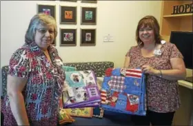  ?? CONTRIBUTE­D PHOTO ?? Quilts that Care volunteer Diane Page recently presented a donation to Christine Tatem of Connecticu­t Children’s Medical Center in Hartford.