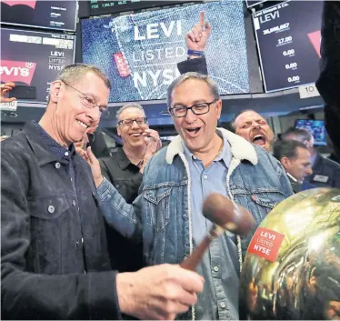  ?? RICHARD DREW THE ASSOCIATED PRESS ?? Levi Strauss CEO Chip Bergh, left, and CFO Harmit Singh ring the opening bell at New York Stock Exchange Thursday.