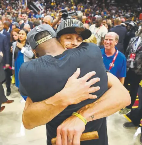  ?? Gregory Shamus, Getty Images ?? The Warriors’ Kevin Durant, left, and Stephen Curry hug after helping their team sweep its way to the NBA Finals title on Friday night in Cleveland. Golden State beat the Cavaliers 108-85.