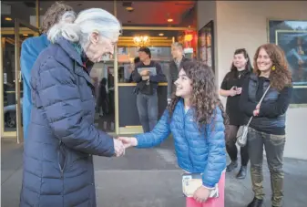  ?? Peter DaSilva / Special to The Chronicle ?? Above: Jane Goodall greets Kaika Dunayevich, 10, before a special screening of “Jane” at the Vogue Theatre. At left: Goodall in the documentar­y.