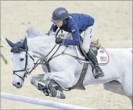  ?? THE ASSOCIATED PRESS] [NATI HARNIK/ ?? Laura Kraut of the United States, riding Zeremonie, practices for the FEI World Cup equestrian jumping competitio­n in Omaha, Neb.