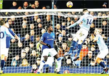  ?? PAUL ELLIS/AFP ?? Manchester City’s French defender Aymeric Laporte jumps to head the ball and scores the opening goal against Everton at Goodison Park in Liverpool, north west England on Wednesday.