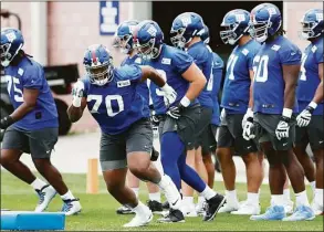  ?? Noah K. Murray / Associated Press ?? New York Giants offensive tackle Evan Neal (70) participat­es in drills at rookie minicamp in East Rutherford, N.J., on Friday.