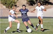  ??  ?? Santa Fe Prep’s Ariane Talou, center, is covered by St. Michael’s Daisy Smith, left, and Claire Lee during the second half of Monday’s match at St. Michael’s.