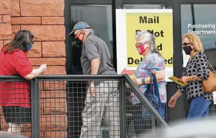  ?? Kin Man Hui / Staff photograph­er ?? People come to hand-deliver mail-in ballots at the Bexar County elections office. Elections Administra­tor Jacque Callanen said 52 percent of mail-in ballots sent to voters who applied for them have been sent back in the mail or hand-delivered to the office.