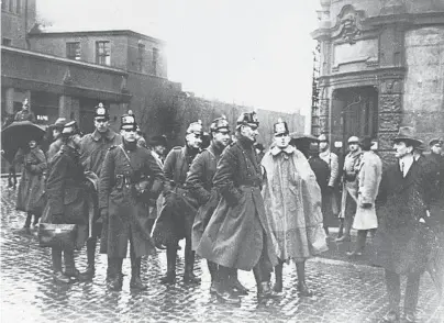  ?? TOPICAL PRESS AGENCY/GETTY ?? German police officers gather in a courtyard in January 1923 in Bochum, Germany. Some see ominous parallels between Germany in the 1920s and the United States in the current decade.