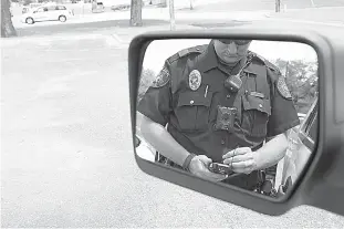  ?? Staff photo by Evan Lewis ?? Over the past year, the Texarkana, Texas, Police Department has made a number of advances, including in the way officers write citations. In this photo, Officer Daniel Linn demonstrat­es the use of an electronic ticket writer.