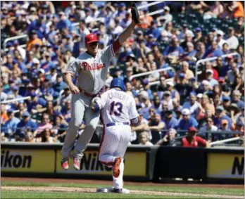  ?? FRANK FRANKLIN II — THE ASSOCIATED PRESS ?? Phillies first baseman Tommy Joseph loses control of the ball as the Mets’ Asdrubal Cabrera (13) beats the throw to first base Sunday in New York. Cabrera was injured on the play.