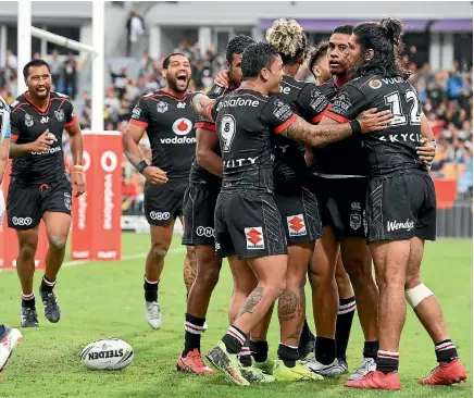  ?? PHOTO: PHOTOSPORT ?? The Warriors celebrate a try during their win over the Gold Coast Titans last week. The victory made them two from two for the new NRL season.