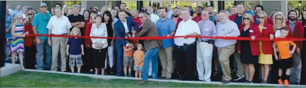  ??  ?? Community members gather for the ribbon-cutting at the new center.